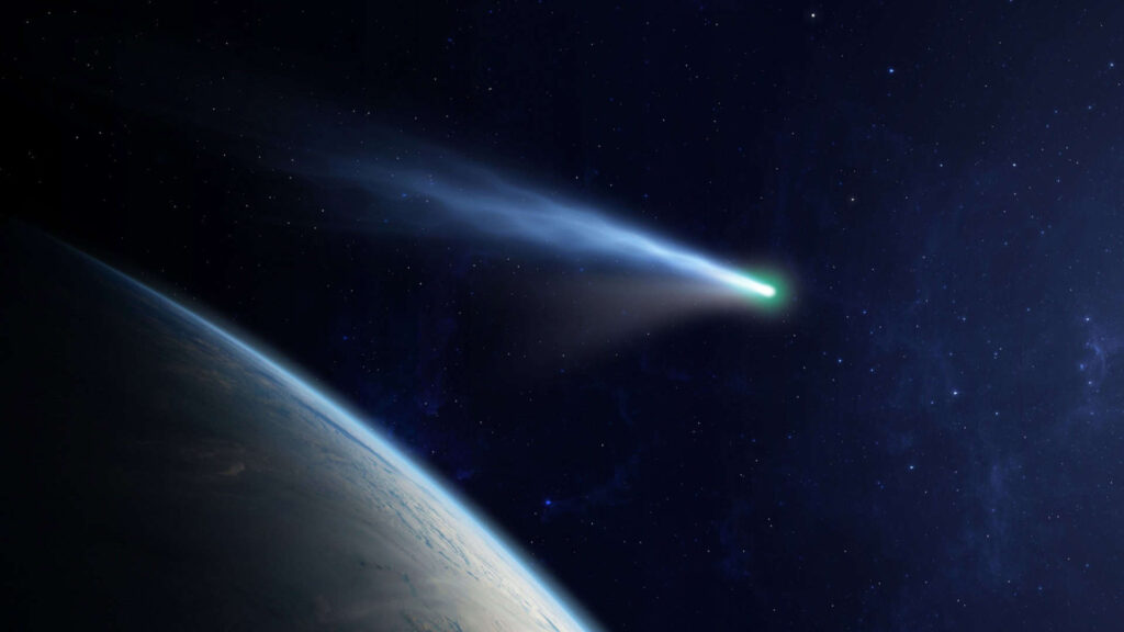 Cometa cruzando o espaço, com cauda brilhante, próximo a um planeta azul, ilustrando a vastidão do cosmos.